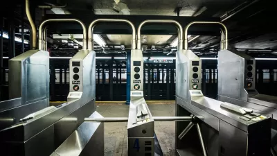 Silver turnstiles at a subterranean subway station