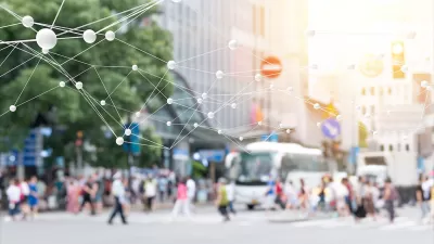 Blurred image of pedestrians on busy street with 'smart city' network rendering superimposed.
