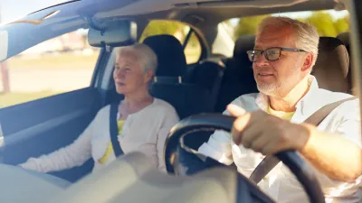 Senior couple driving car.