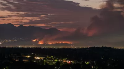 Nighttime view of wildfire in Los Angeles hills.