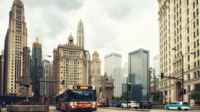 Public transit bus on Chicago street with tall historic buildings in background.