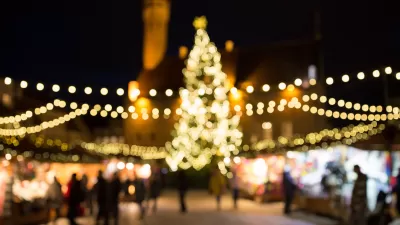 Blurred image of Christmas lights at nighttime draped over Christmas market in Tallin, Estonia.