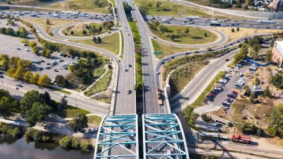 Aerial view of wide roadway and arc bridge in Denver, Colorado.