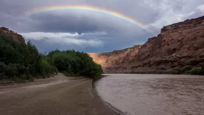 Rainbow over red rocks and river in Utah's Labyrinth Canyon.