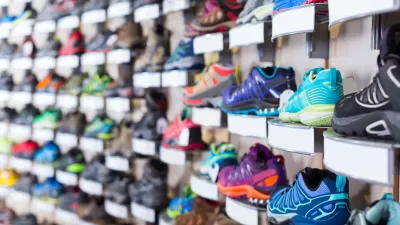 Wall of colorful sneakers for sale at a shoe store.