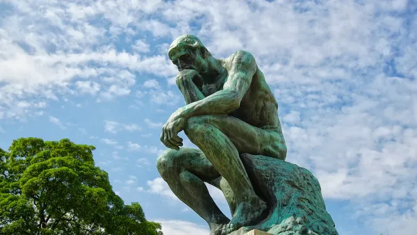 The Thinker sculpture by Rodin installed outdoors.