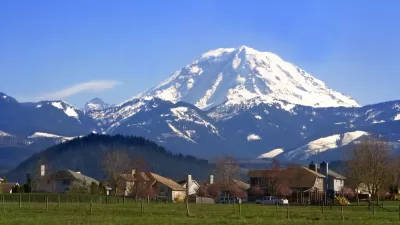 Homes in rural area with snowy Mt. Rainier in background in Washington state.