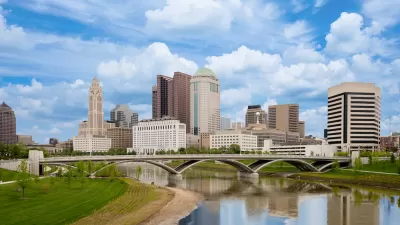 Skyline of Columbus, Ohio with bridge and river.