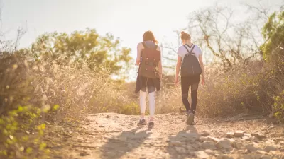 Two young women hiking at golden hour.