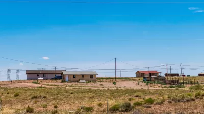 View of three manufactured homes on a hill somewhere in Navajo Nation