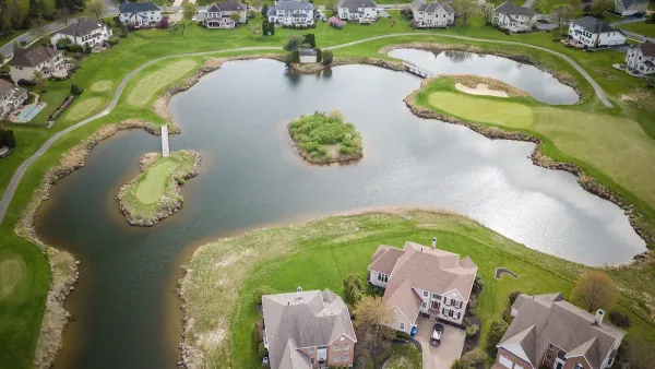 Aerial view of large suburban homes on small lake in Mount Laurel, New Jersey.