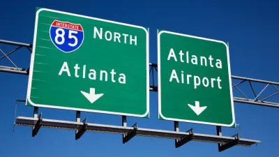 Green freeway signs for Atlanta and Atlanta airport on Interstate 85.