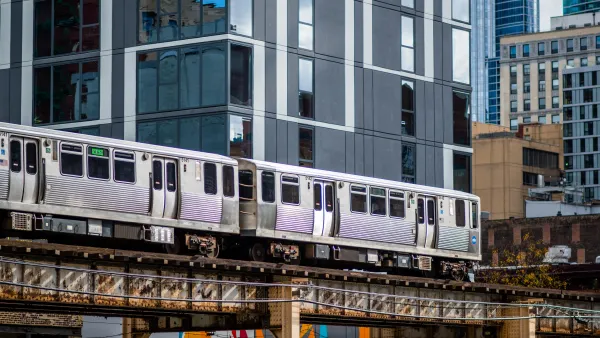 View of CHicago elevated train passing by multistory building downtown