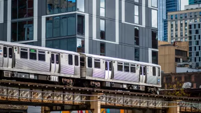View of CHicago elevated train passing by multistory building downtown