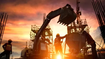 Construction workers, bulldozer, and unfinished bridge or highway sillhouetted against orange sunset sky