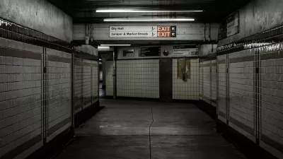 Empty hallway lined with white tile in subway station in Philadelphia, Pennsylvania.