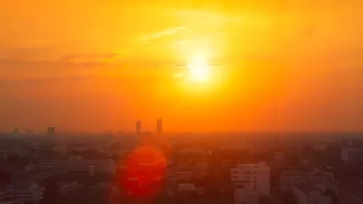 View of city skyline in red smog indicating extreme heat.