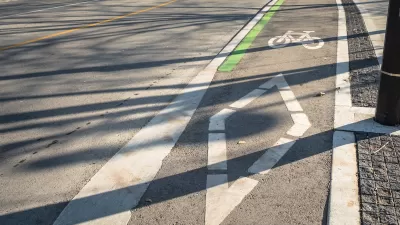 Painted bike lane with bike symbol and diamond on street in downtown Toronto, Ontario.