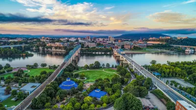 Aerial view of Chattanooga, Tennessee with two bridges over river in background.