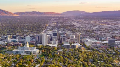 Aerial view of Salt Lake City, Utah with capitol dome in foreground again sunset sky.