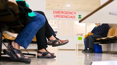 Close-up on the bottom half of people sitting in a hospital waiting room.