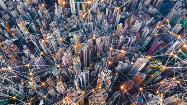 Aerial view of dense urban center with lines indicating smart city concept.