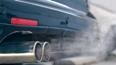 Close-up of car tailpipe emitting white smoke
