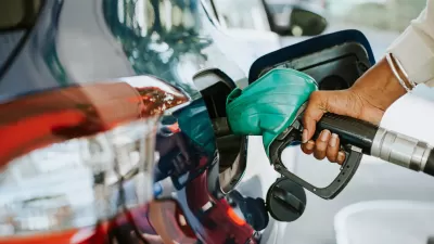 Close-up of hand filling car with gas at gas pump