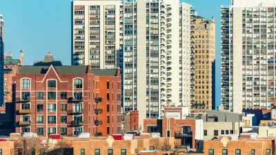 View of Chicago Old Town neighborhood with low-rise brick buildings in foreground and tall residential high-rises in background.