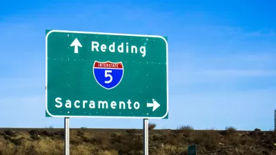 Close-up of green Interstate 5 freeway sign pointing to Redding and Sacramento.