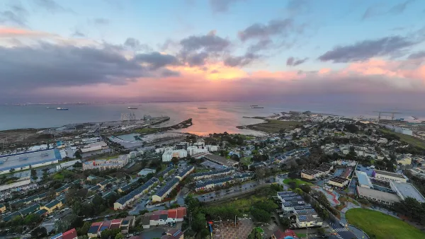 Aerial of the Hunters Point neighborhood in San Francisco, California with sun setting over the water.