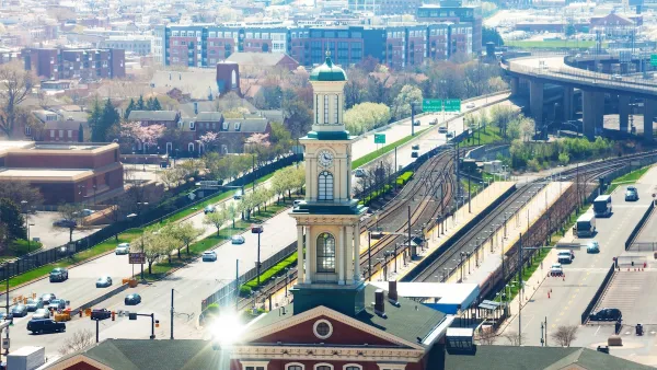 Aerial view of Camden Station train station in Baltimore, Maryland. Train station is brick neoclassical building with three-tier tower.