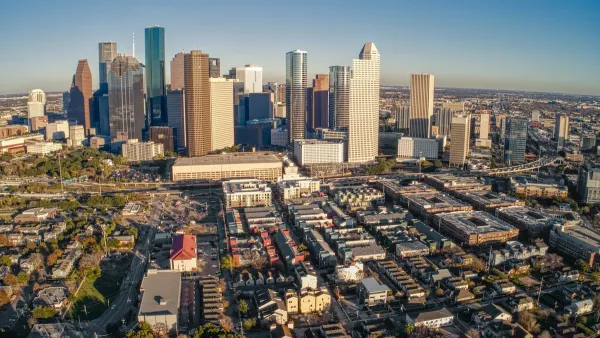 Aerial view of downtown Houston, Texas skyline with low-rise housing in foreground.