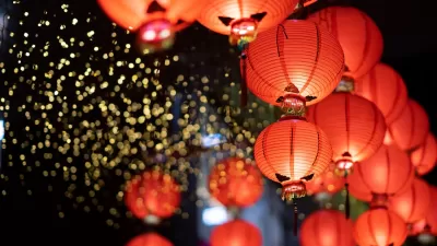 Close-up of cluster of red paper Lunar New Year lanters at night.