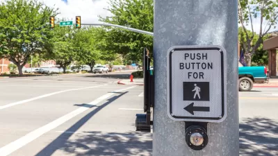 CLose-up of pedestrian call button on pole at intersection
