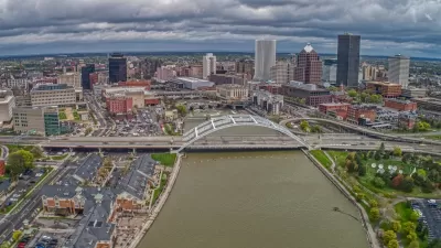 Aerial view of downtown Rochester, New York with river and bridge in foreground.