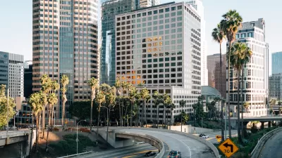 View of 110 freeway with downtown Los Angeles buildings in background.