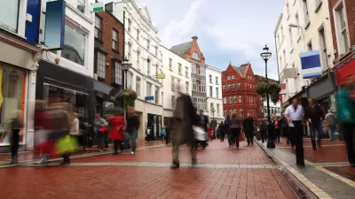 Pedewstrianized street paved with red bricks flanked by historic four-story buildings in Dublin, Ireland