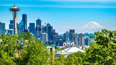 View of Seattle skyline on clear sunny day with Space Needle on left and Mount Rainier in the background.