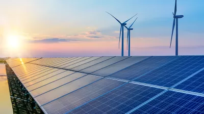 Solar panels and wind turbines against sunset colors