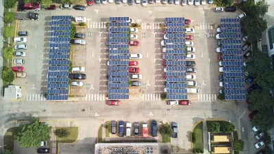 Bird's eye view of parking lot with solar panel canopies