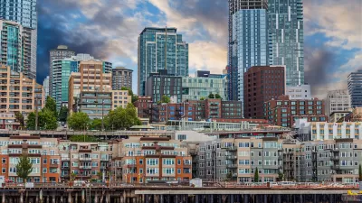 View of dense apartment buildings on Seattle waterfront with high-rise buildings in background.