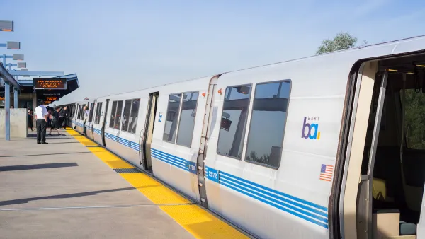BART train at outdoor above-ground station in Oakland, California