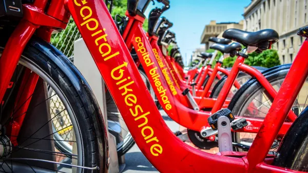 Close-up of red Capital Bikeshare bikes parked at statio on sidewalk in Washington D.C.