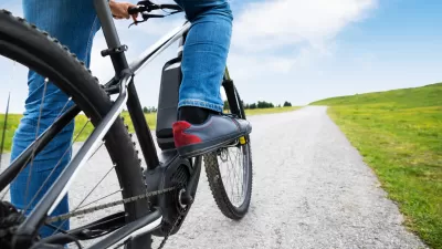 Close-up of person on electric mountain bike on gravel path