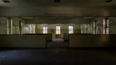 Abandoned wing of Creedmoor Hospital, Queens New York with long row of windows and 'Reading Room' visible on wall