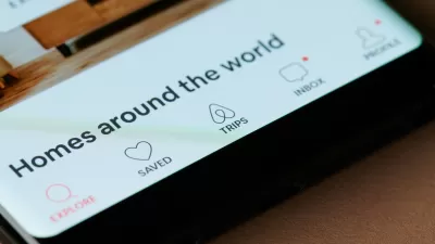 Close-up of phone screen with Airbnb app screen