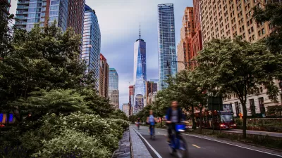 Blurred view of cyclists riding in protected bike lane