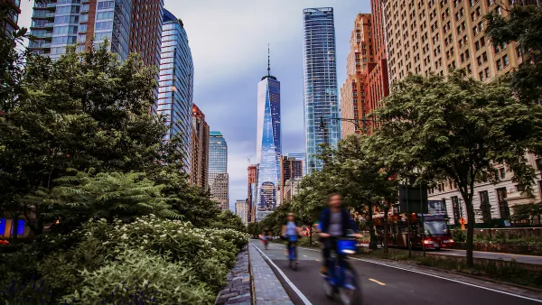 Blurred view of cyclists riding in protected bike lane 