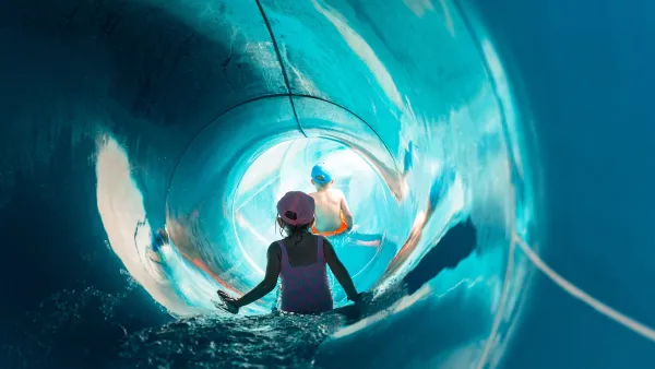 Children inside large slide at water park.